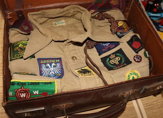 Two Bukta scout shirts with badges, 1950s-60s in a case